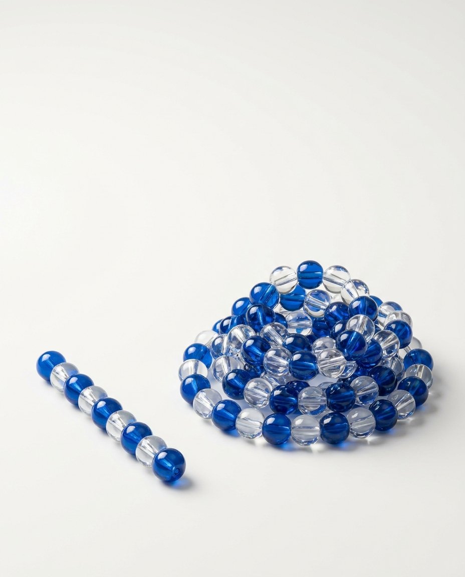 A short chain of blue and clear glass beads beside a long coiled chain of the same beads.